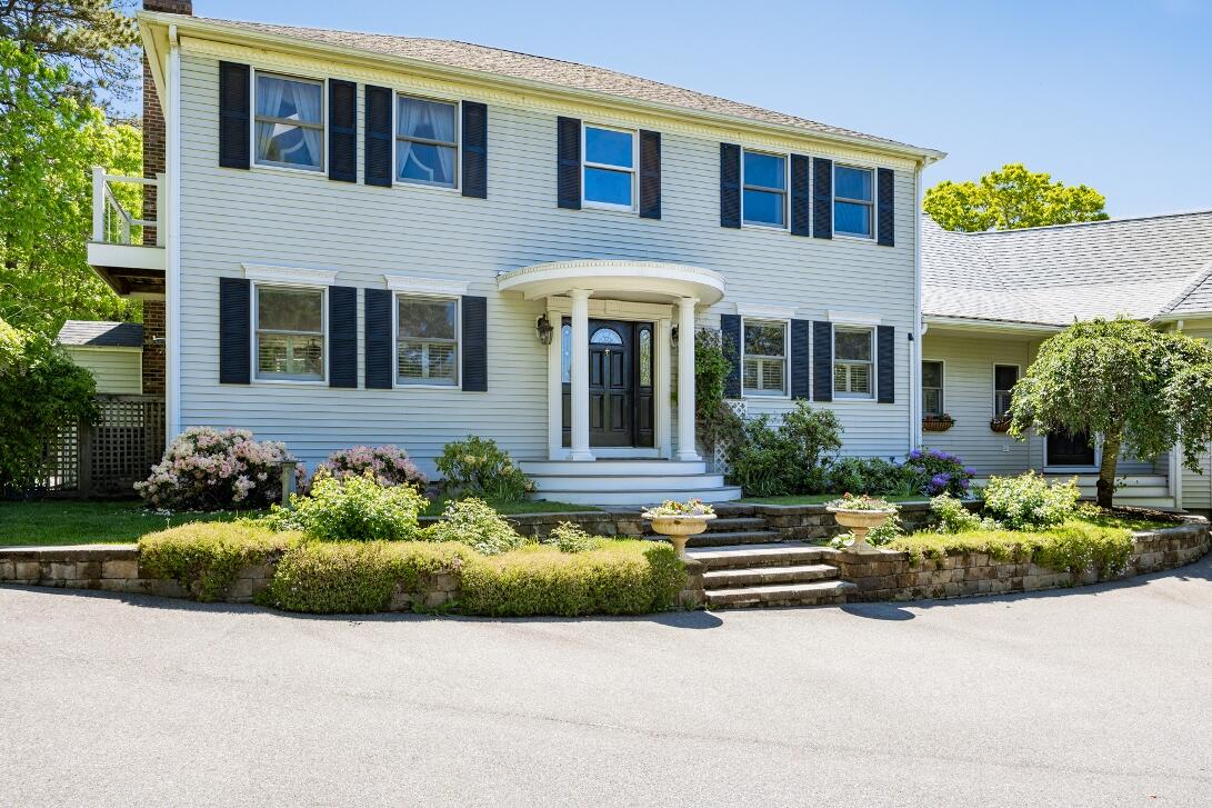 227 Run Hill Road Brewster, MA 02631 - Photo 6 of 89 a front view of a house with a yard and outdoor seating
