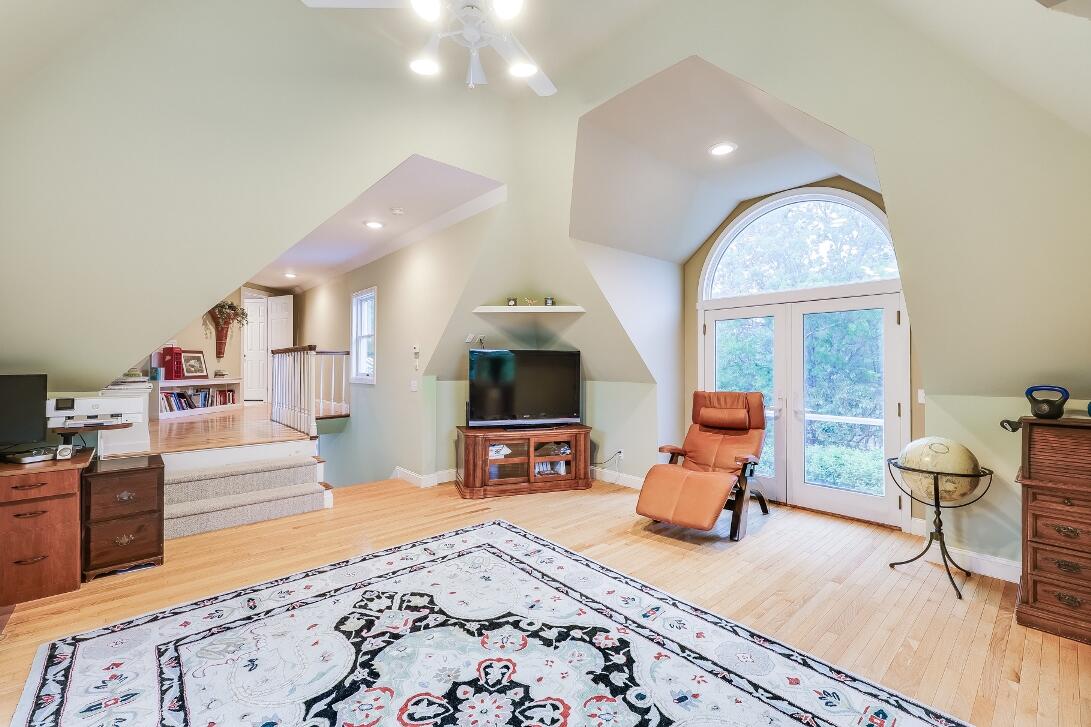 227 Run Hill Road Brewster, MA 02631 - Photo 63 of 89 a living room with furniture flat screen tv and a fireplace