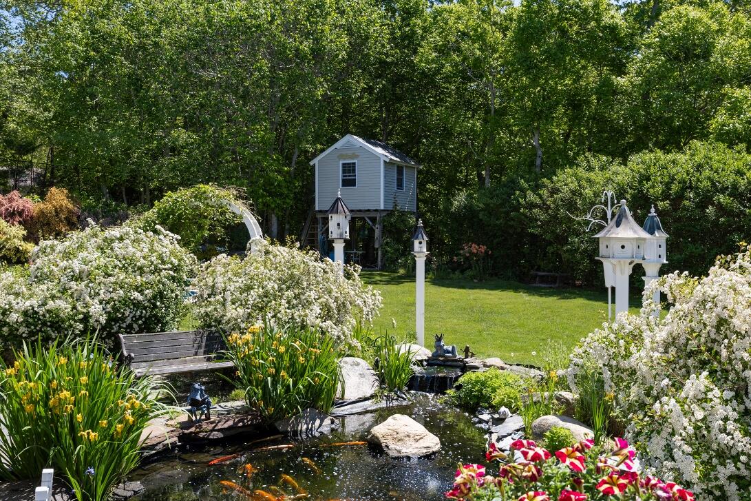 227 Run Hill Road Brewster, MA 02631 - Photo 80 of 89 a front view of a house with a big yard and potted plants