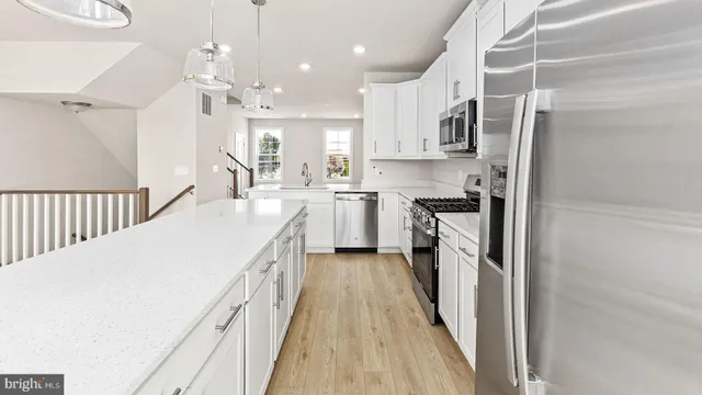 a kitchen with cabinets a sink and appliances