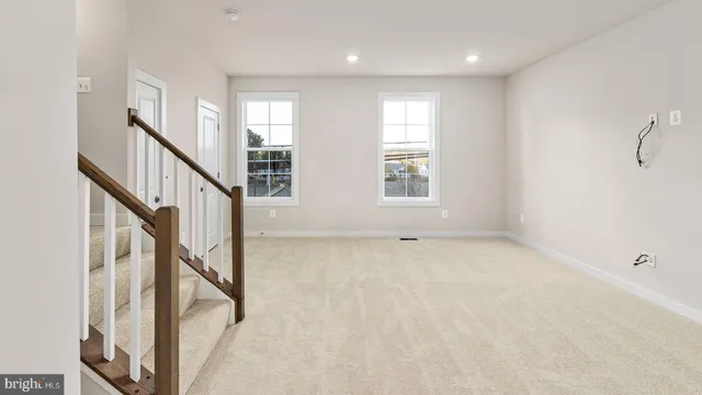 a view of an entryway with wooden floor and windows