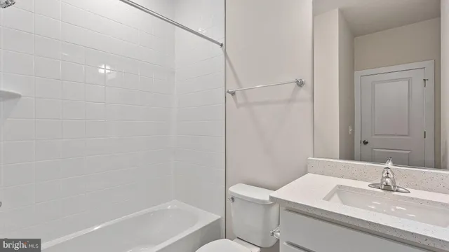 a bathroom with a sink toilet vanity and shower