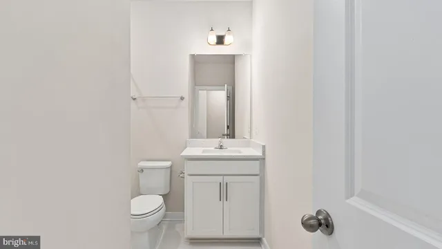 a bathroom with a sink toilet and vanity