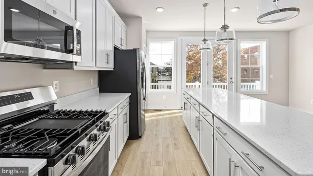 a kitchen with stainless steel appliances a sink and a stove