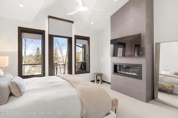 a bedroom with a large bed and a large window