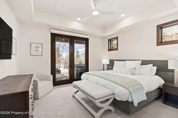 a spacious bedroom with a large bed and a tv