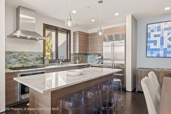 a kitchen with a stove a sink and a refrigerator