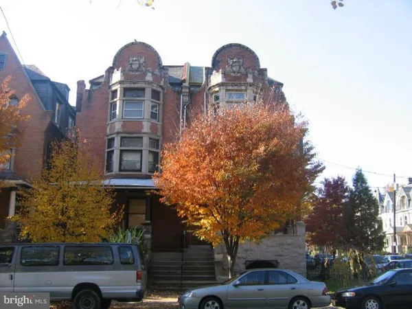 a couple of cars parked in front of a house