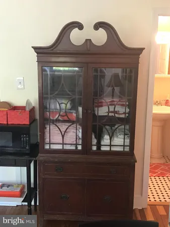 a living room with furniture a rug and a piano