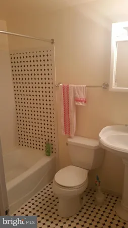 a bathroom with a sink toilet and mirror