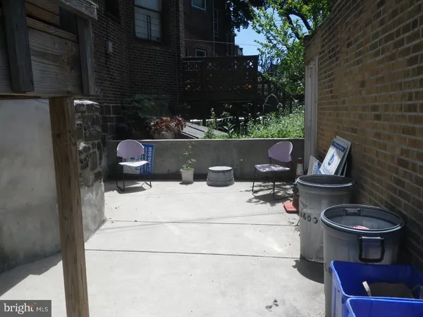 a front view of a building with trees