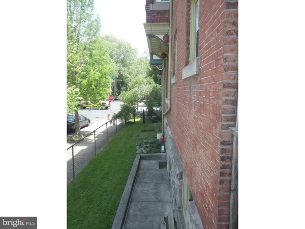 a view of a brick building next to a yard