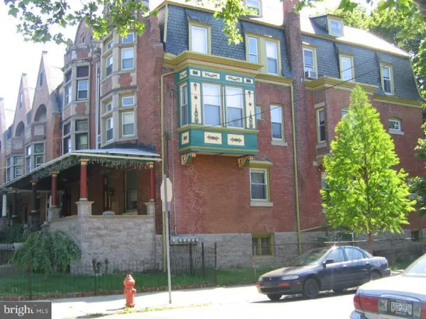 a view of a brick house with a small porch
