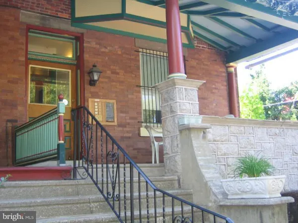 a dining room with furniture and a floor to ceiling window