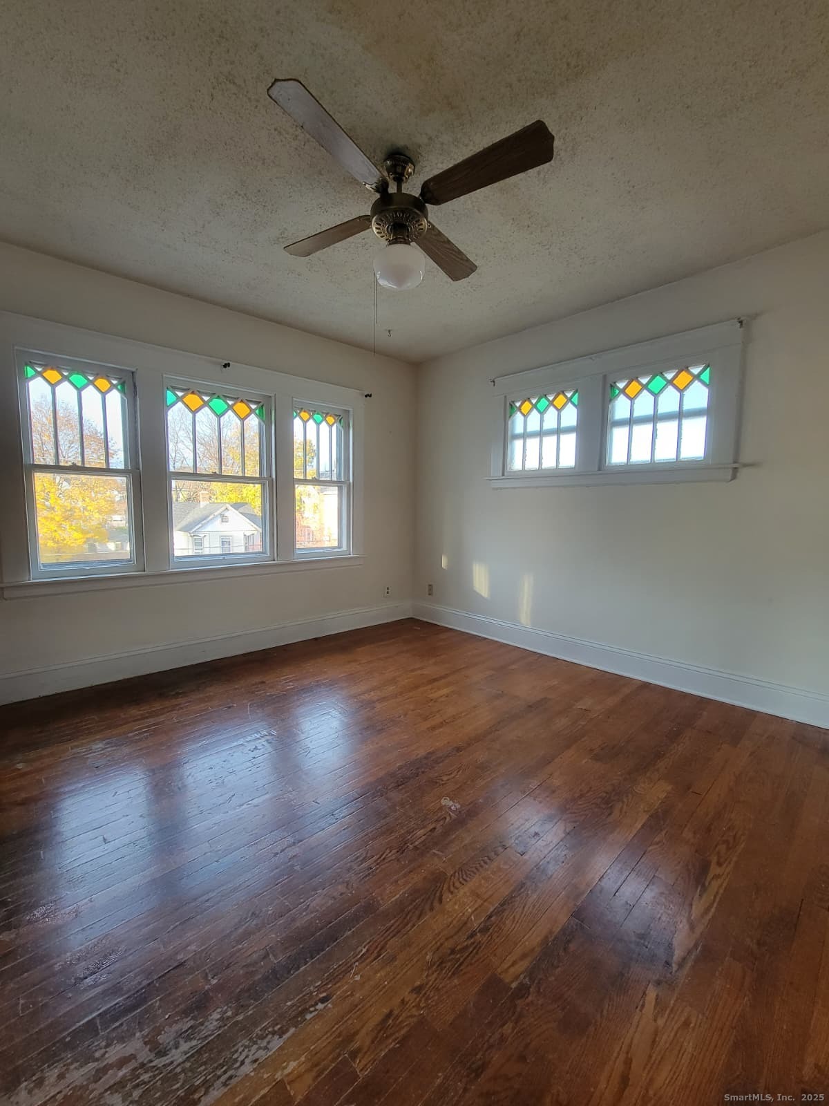45 Belden Street New Britain, CT 06051 - Photo 1 of 11 an empty room with wooden floor and windows