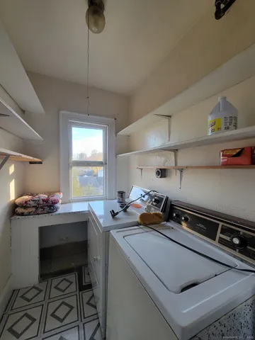 a kitchen with a sink a stove and cabinets