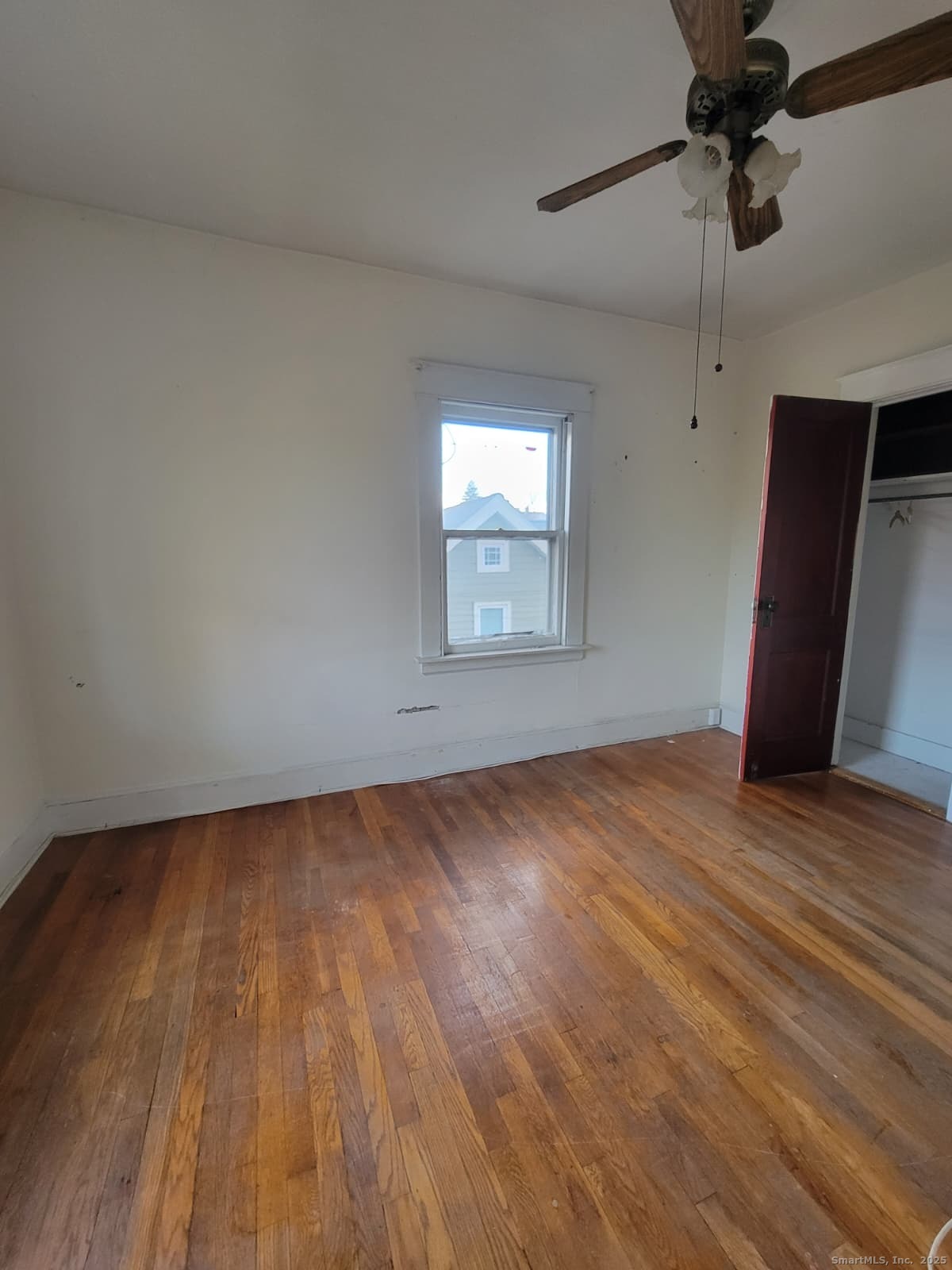 45 Belden Street New Britain, CT 06051 - Photo 9 of 11 a view of an empty room with a window and wooden floor