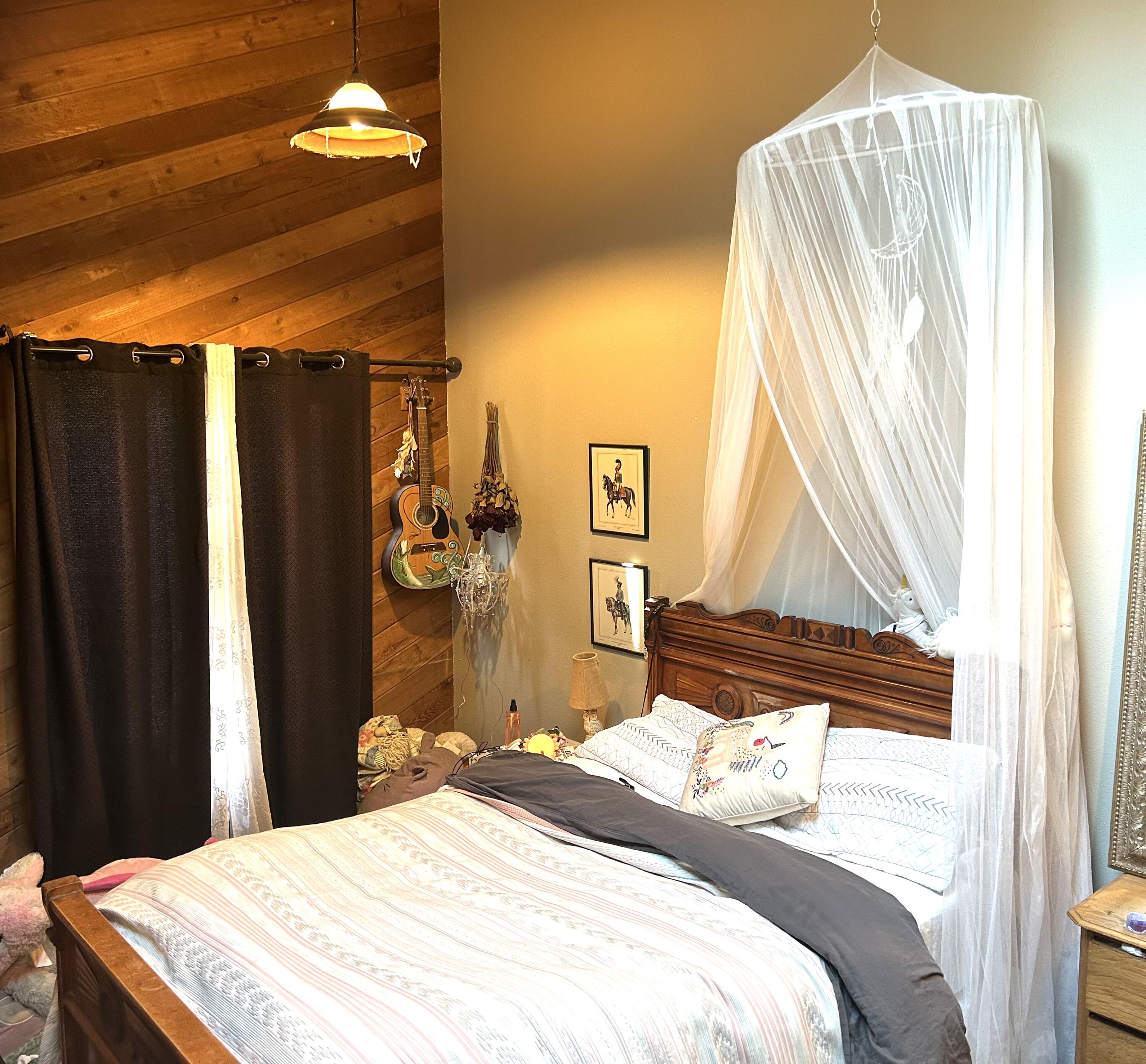 68964 Graham Court Sisters, OR 97759 - Photo 14 of 28 a bedroom with a bed and a window