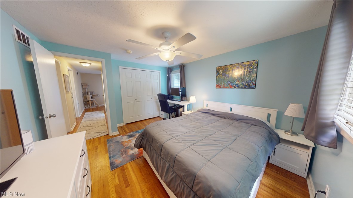 1071 Roland Road Lyndhurst, OH 44124 - Photo 23 of 30 Bedroom featuring multiple windows, light hardwood floors, and ceiling fan
