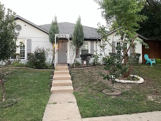 a front view of a house with a yard and fountain