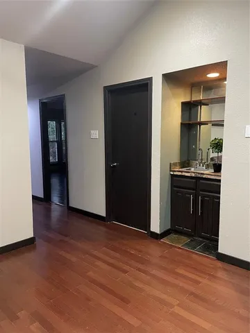 an empty room with wooden floor and closet