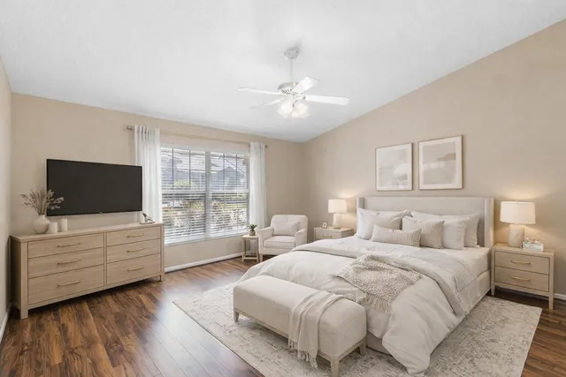 a bedroom with a bed and a flat screen tv