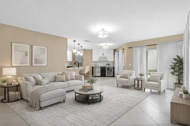 a living room with furniture and view of kitchen