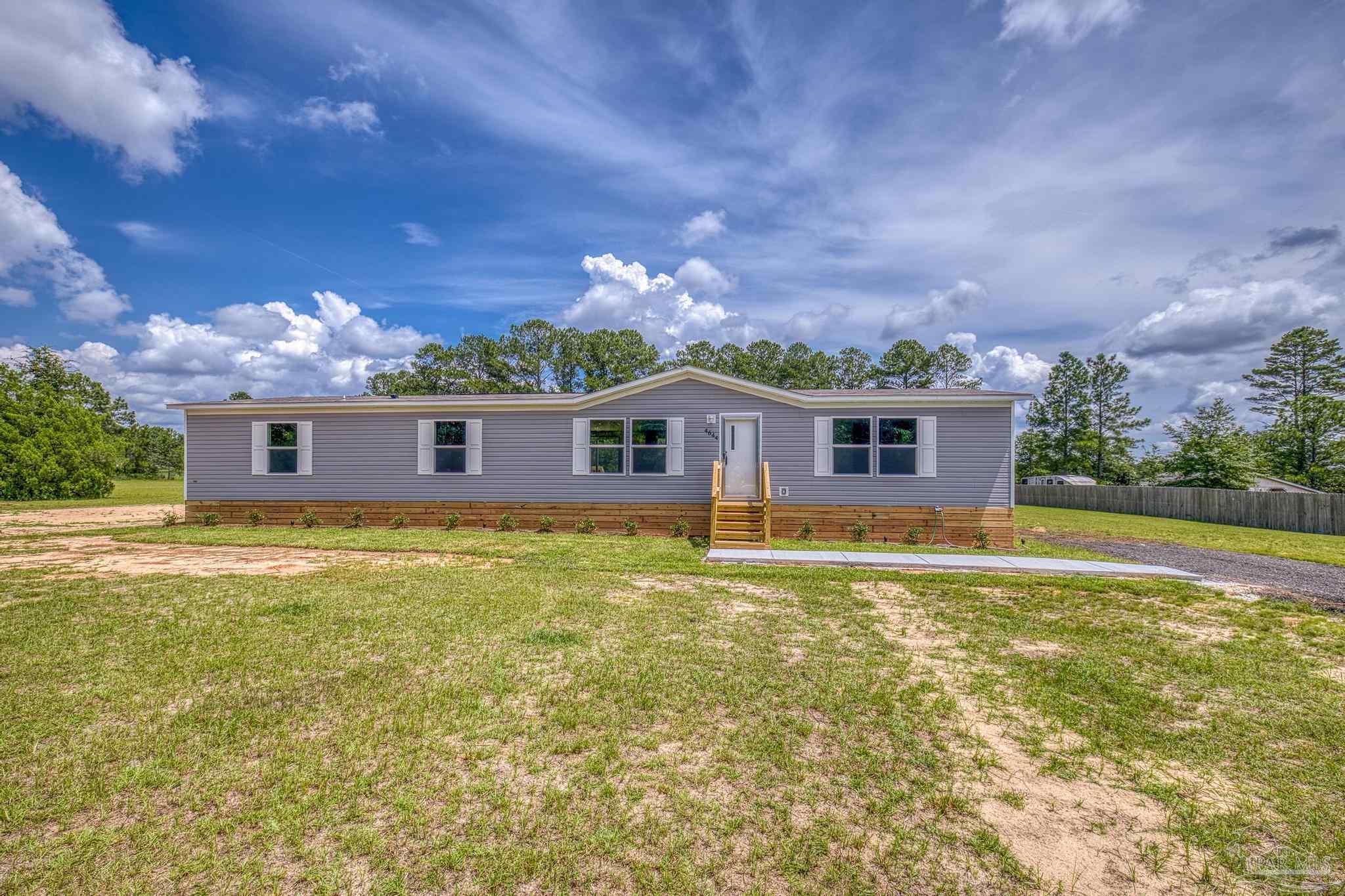 4644 Farm Life Road Milton, FL 32583 - Photo 1 of 39 a front view of house with yard and entertaining space