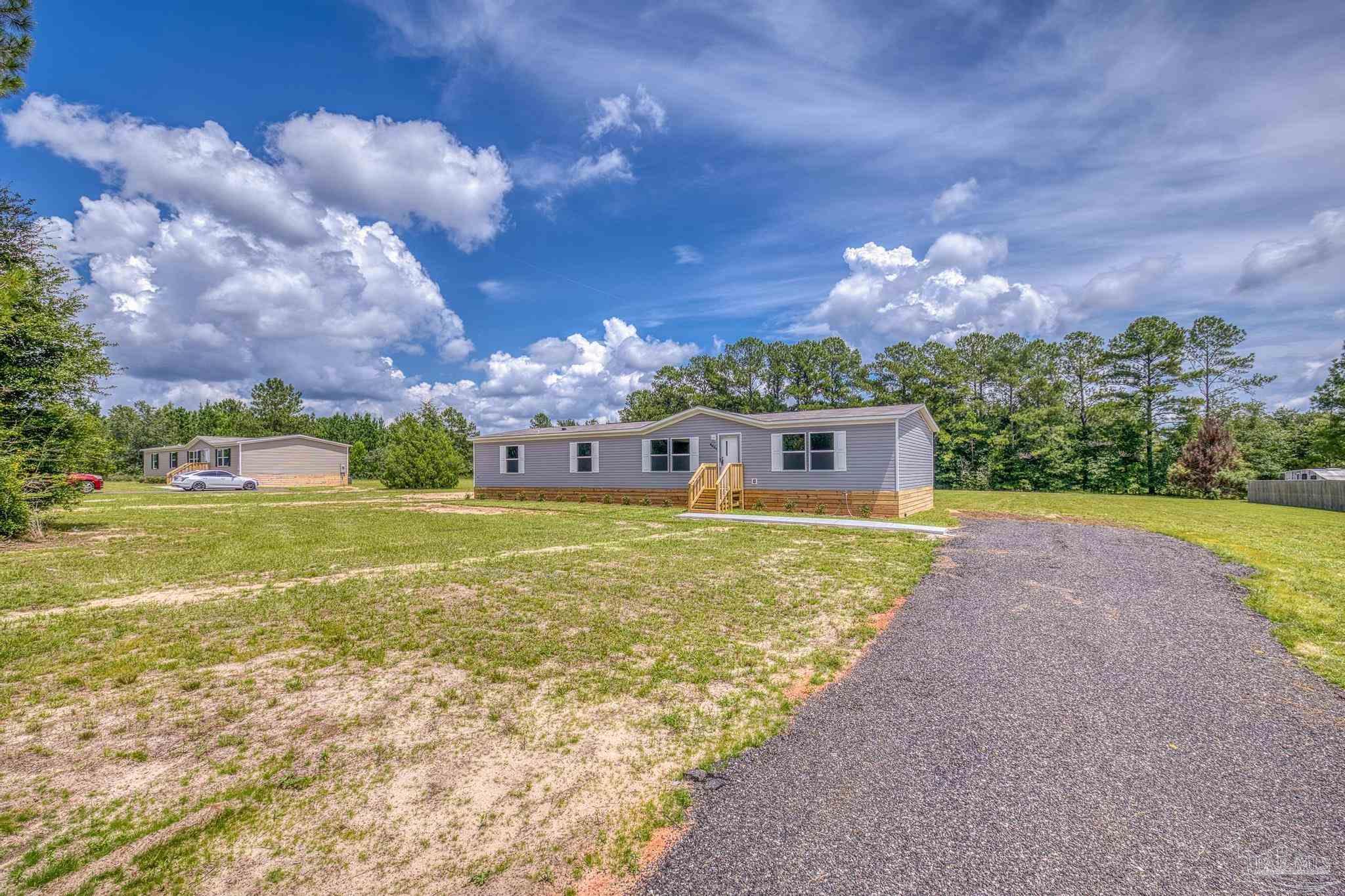 4644 Farm Life Road Milton, FL 32583 - Photo 2 of 39 a view of a house with a big yard