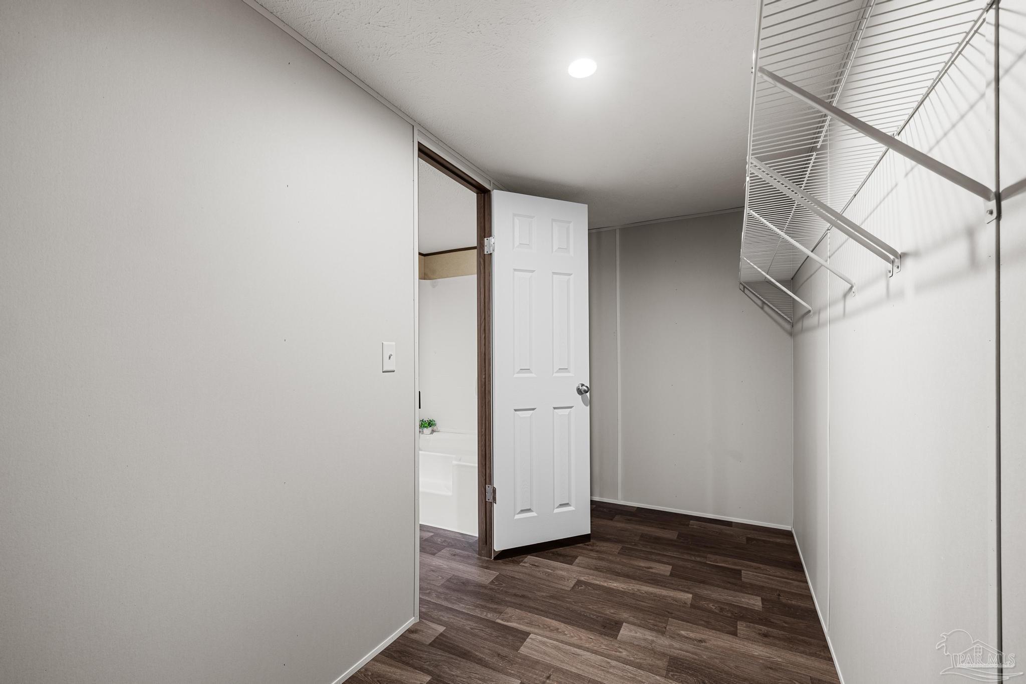 4644 Farm Life Road Milton, FL 32583 - Photo 23 of 39 a view of hallway with wooden floor
