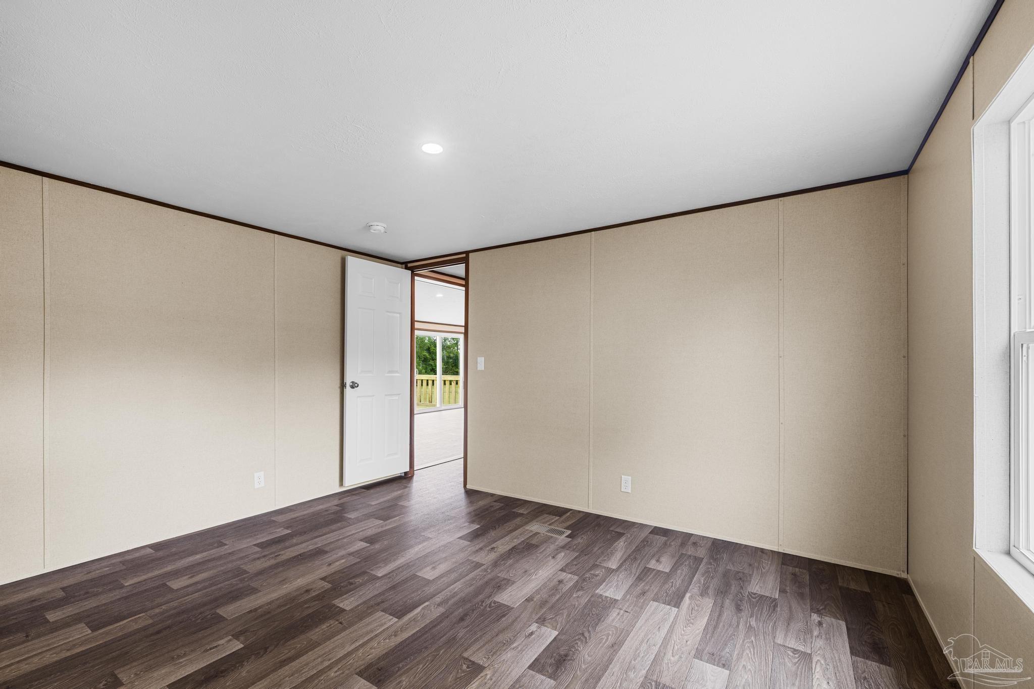 4644 Farm Life Road Milton, FL 32583 - Photo 30 of 39 a view of an empty room with wooden floor