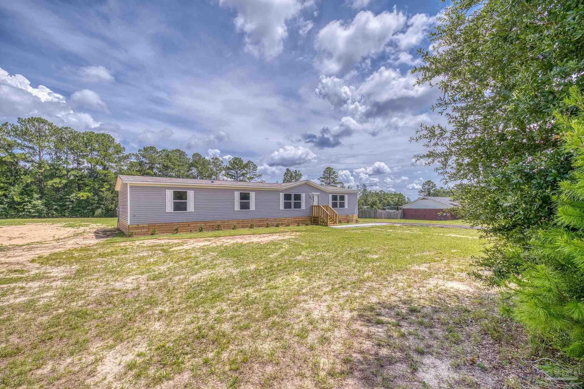 4644 Farm Life Road Milton, FL 32583 - Photo 3 of 39 a view of a house with a yard