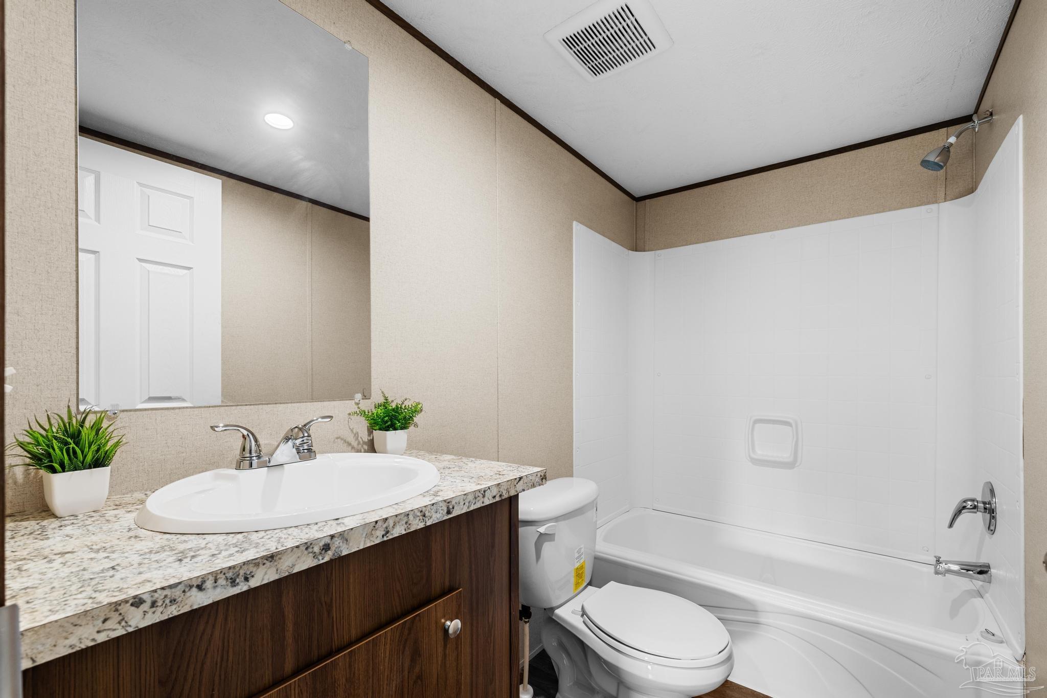 4644 Farm Life Road Milton, FL 32583 - Photo 31 of 39 a bathroom with a granite countertop sink a toilet and shower