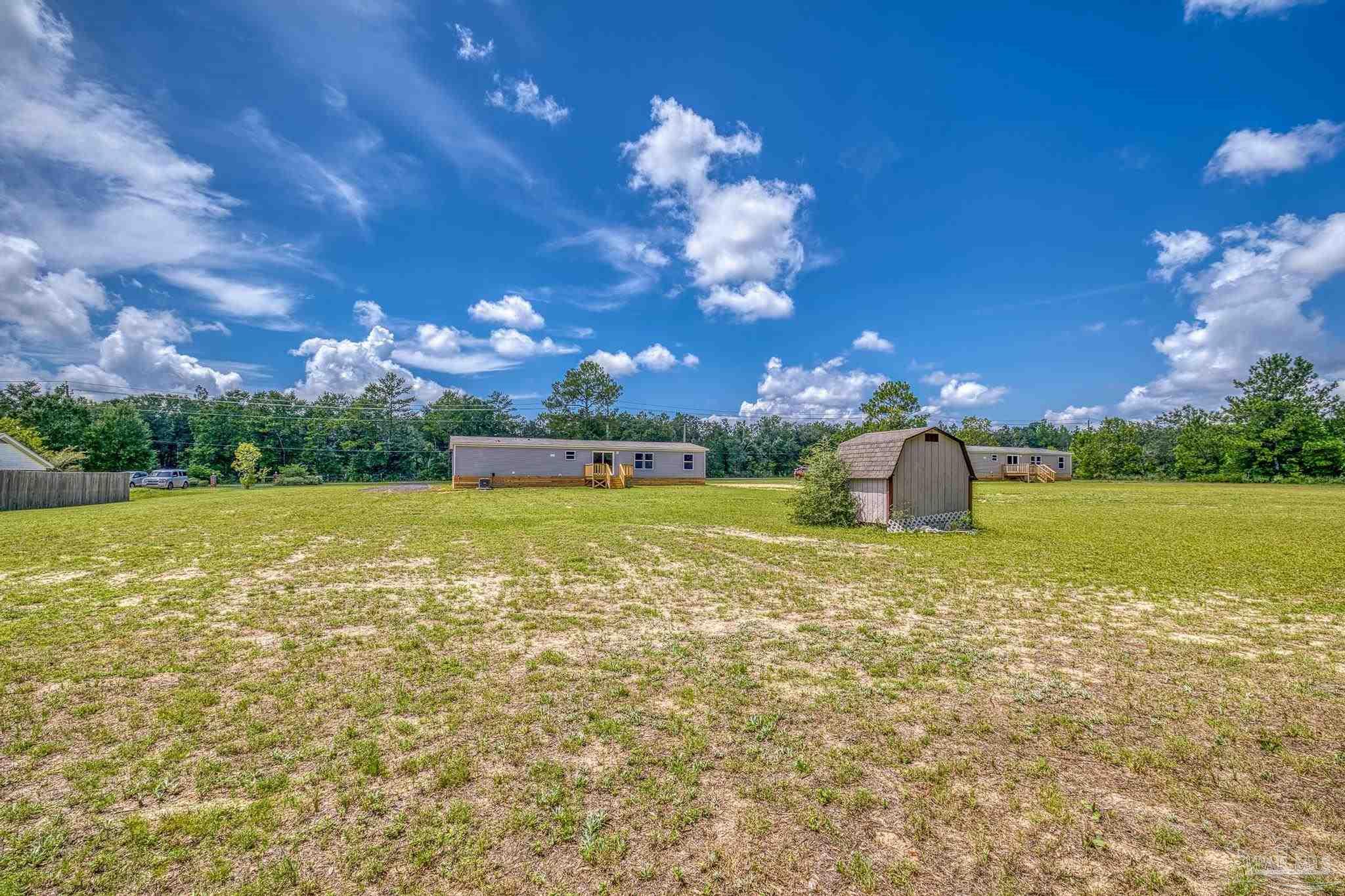 4644 Farm Life Road Milton, FL 32583 - Photo 33 of 39 a view of a lake with a big yard