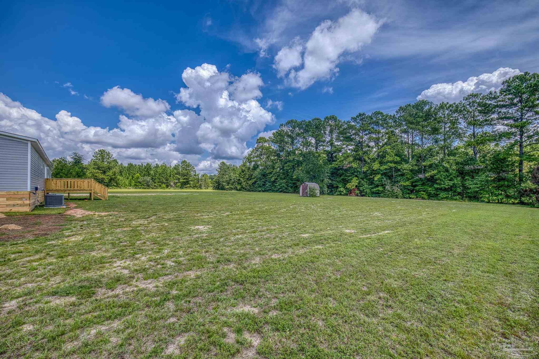 4644 Farm Life Road Milton, FL 32583 - Photo 36 of 39 a view of a building with a yard