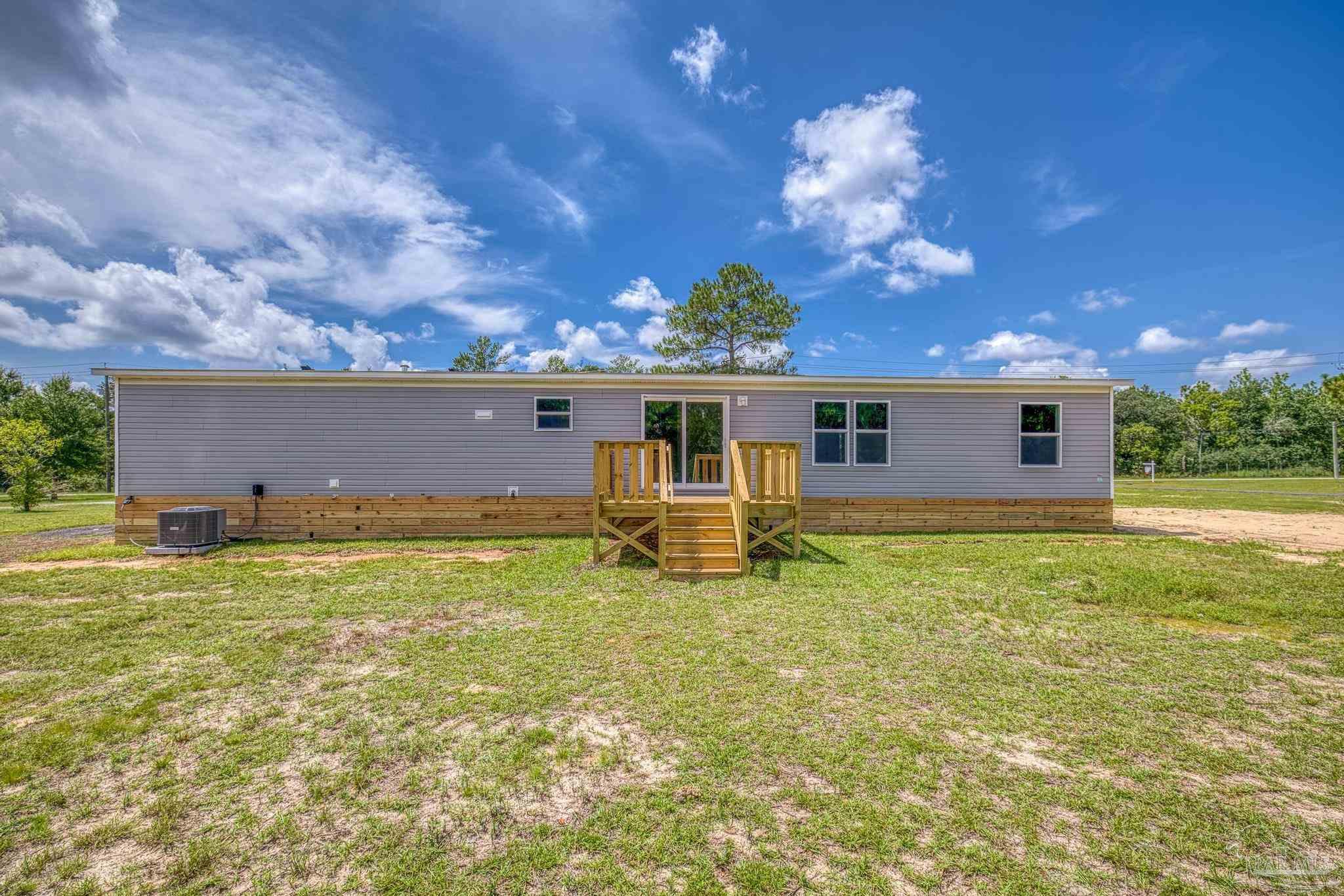 4644 Farm Life Road Milton, FL 32583 - Photo 37 of 39 a view of a house with backyard porch and garden