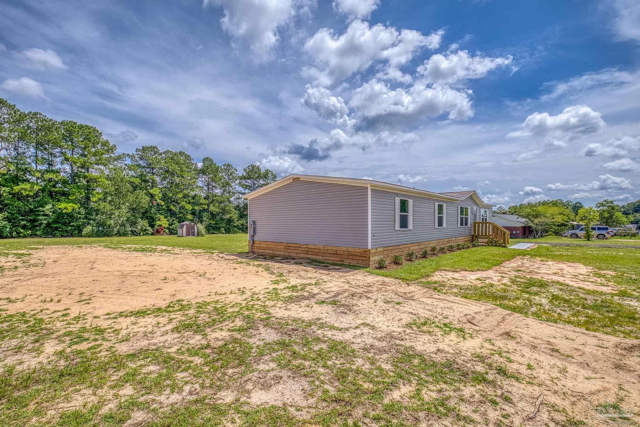 4644 Farm Life Road Milton, FL 32583 - Photo 4 of 39 a backyard of a house