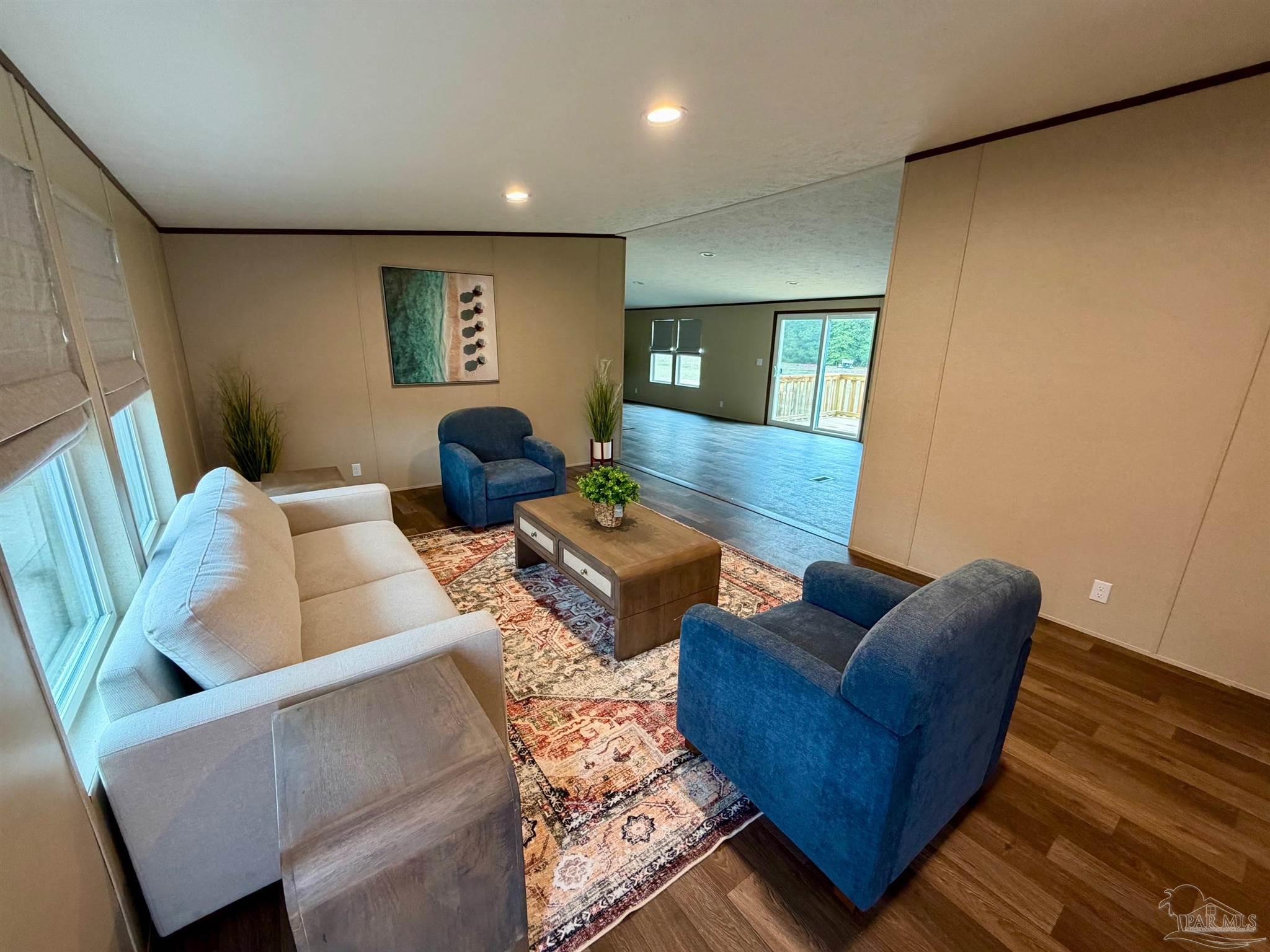 4644 Farm Life Road Milton, FL 32583 - Photo 7 of 39 a living room with furniture and a couch
