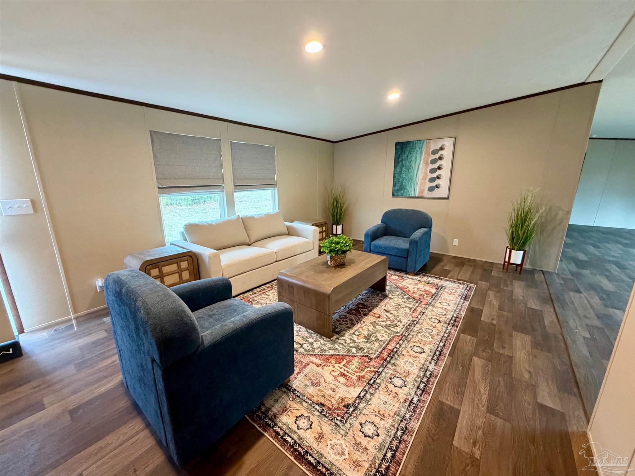 4644 Farm Life Road Milton, FL 32583 - Photo 8 of 39 a living room with furniture and wooden floor
