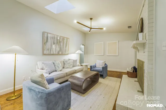 a living room with furniture and a lamp