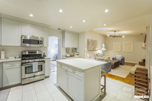a kitchen with a sink a stove and chairs