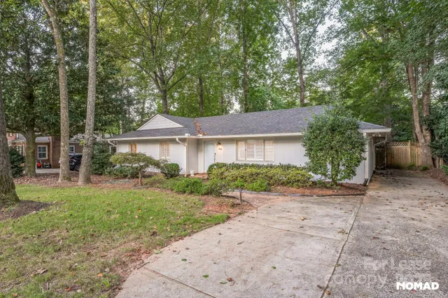 a front view of a house with a yard and a garage