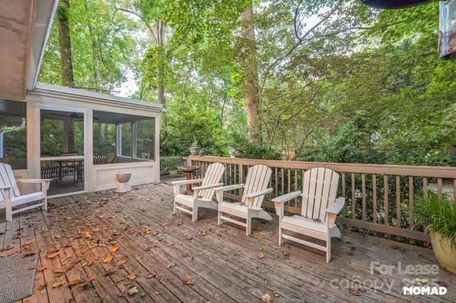 a view of a wooden chairs and bench in the backyard