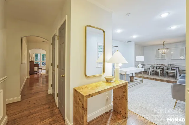 a living room with furniture a table and kitchen view