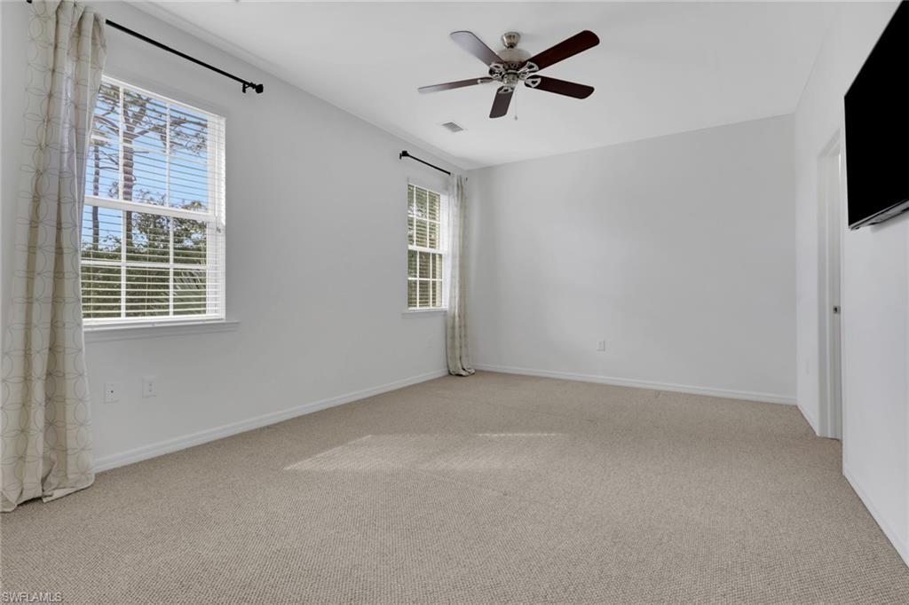 18320 Creekside Preserve Loop, Unit 201 Fort Myers, FL 33908 - Photo 12 of 27 Unfurnished room with light carpet and ceiling fan