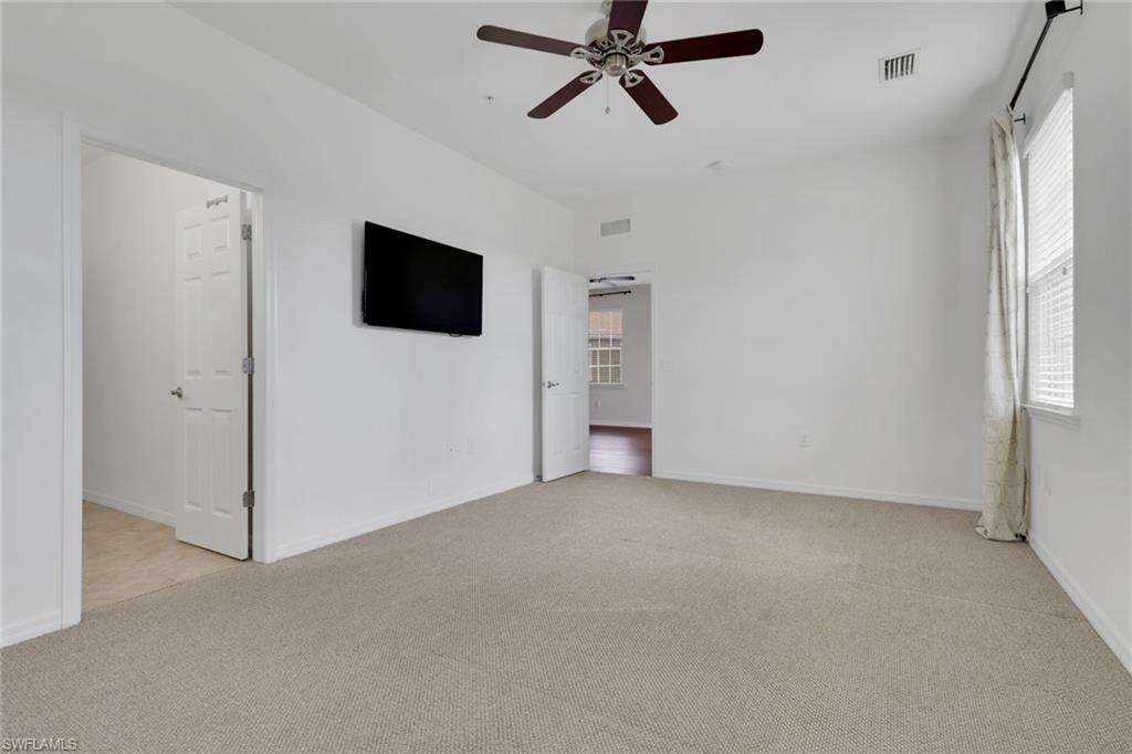 18320 Creekside Preserve Loop, Unit 201 Fort Myers, FL 33908 - Photo 13 of 27 Unfurnished bedroom with light colored carpet and ceiling fan