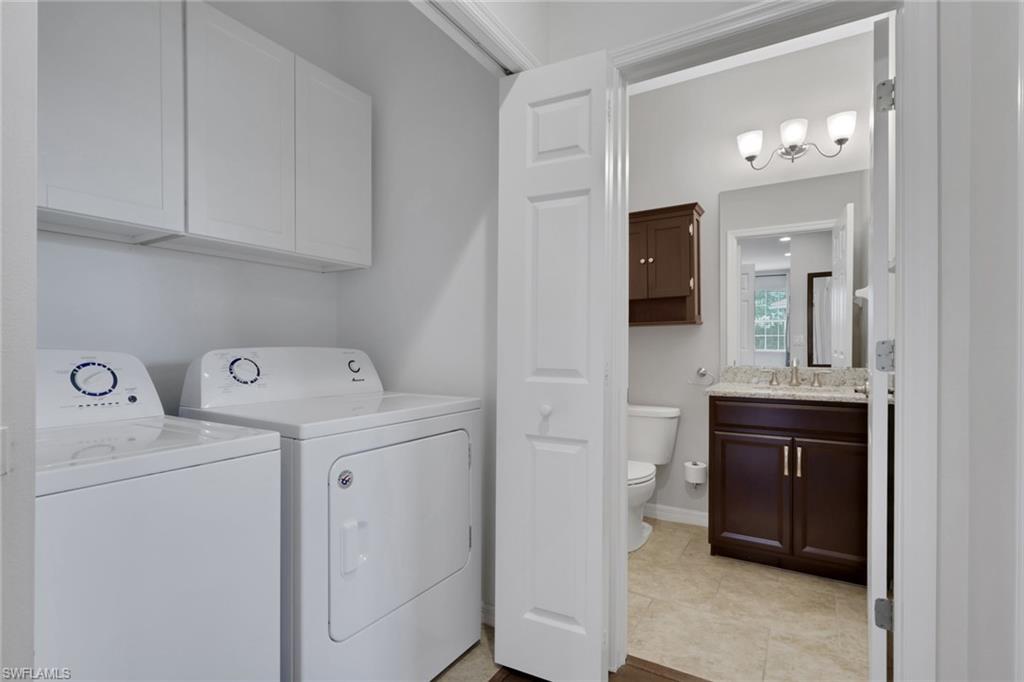 18320 Creekside Preserve Loop, Unit 201 Fort Myers, FL 33908 - Photo 23 of 27 Washroom featuring separate washer and dryer and cabinet space