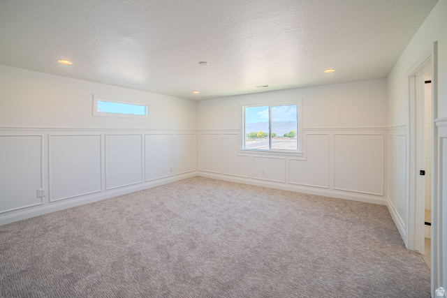 45 North Scarlet Maple Road, Unit 4317 Vineyard, UT 84059 - Photo 19 of 35 Spacious room featuring wainscoting paneling, recessed lighting, and soft gray carpeting