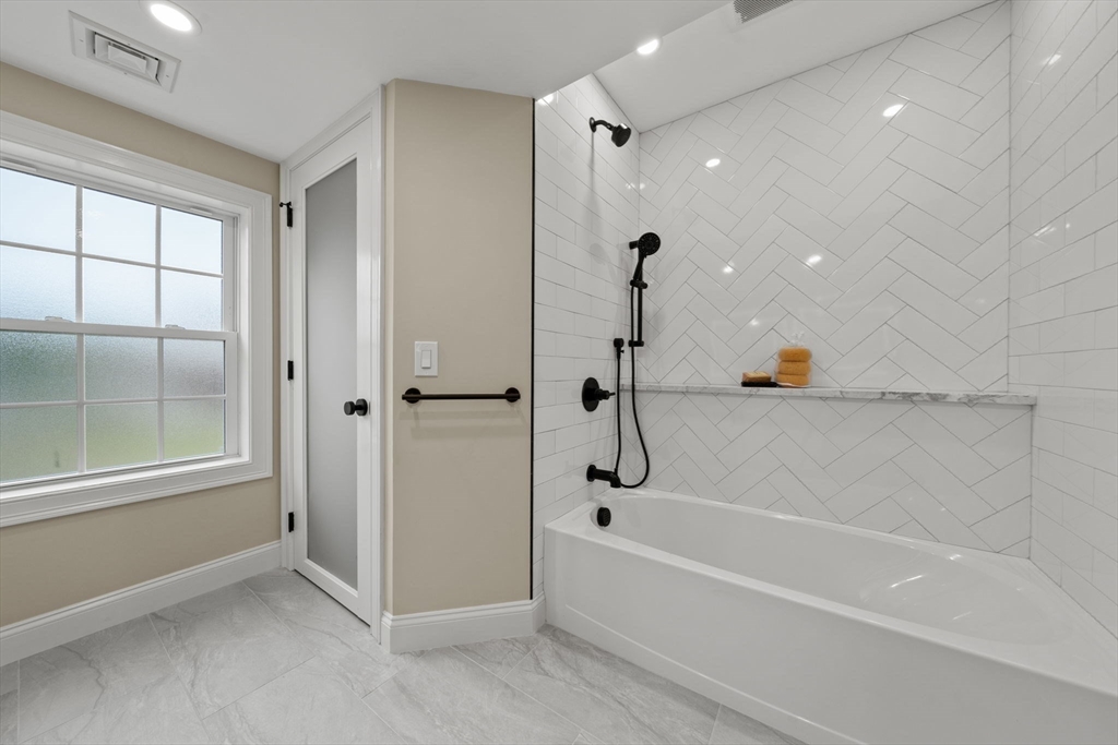 162 High Street, Unit B Danvers, MA 01923 - Photo 27 of 32 a bathroom with a bathtub and a shower