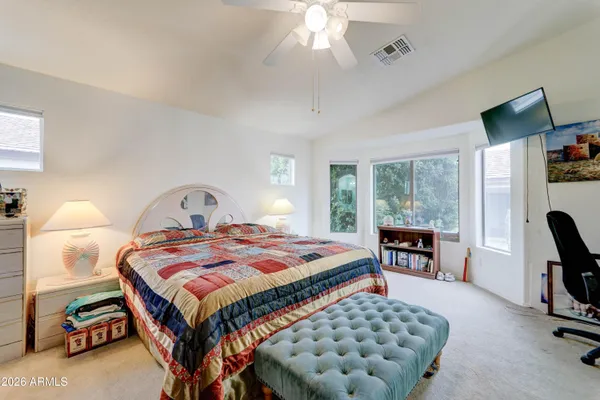 a bedroom with a bed a couch and dresser